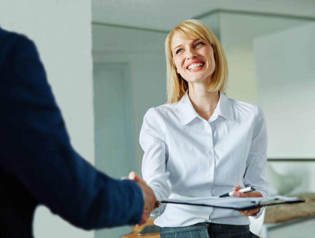 young business businesswoman handshake hand shake shaking meeting agreement office teamwork partner